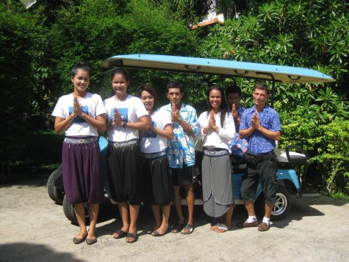 people posing for a picture in front of a van at Paradise Island Estate in Choeng Mon Beach
