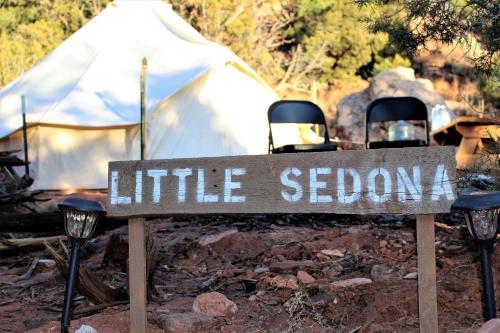a sign in front of a white tent with two chairs at Zion View Camping in Hildale