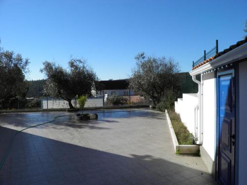 a large empty parking lot next to a building at Casa de São José in Sardoal