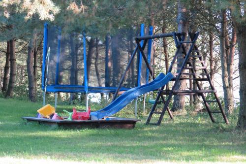 a playground with a blue slide and a slide at Ostoja Stacze in Stacze