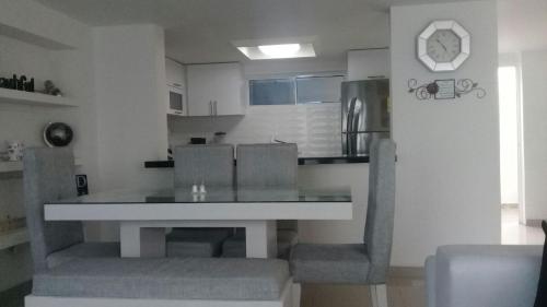 a kitchen with a table and chairs in a room at Sashii Hostel & Boutique. in Ríohacha