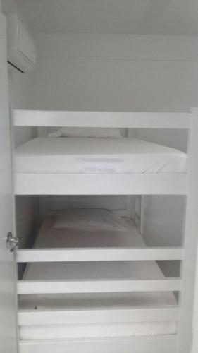 an empty white shelf in a white cabinet at Sashii Hostel & Boutique. in Ríohacha