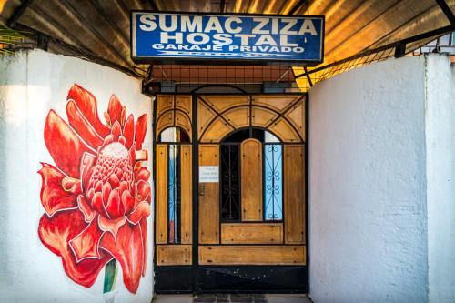 a building with a door with a flower painted on it at Zumag Sisa in Tena