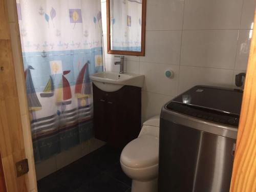 a small bathroom with a toilet and a sink at Cabañas Mirador de Maitencillo in Maitencillo