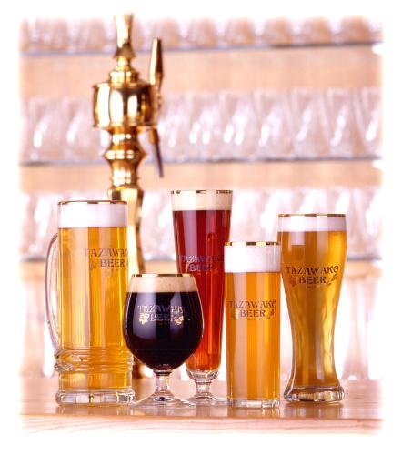 four different types of beer glasses on a table at Onsen Yupopo in Senboku