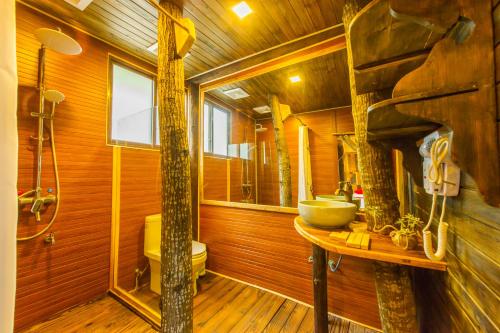 a bathroom with a sink and a toilet and a shower at Rural House in Yangshuo