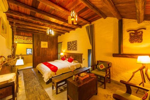 a bedroom with a bed and a desk in a room at Rural House in Yangshuo