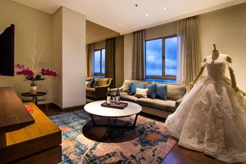 a wedding dress on a mannequin in a living room at Ascott Waterplace Surabaya in Surabaya