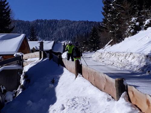 two people standing on a wall in the snow at Ferienhaus Bergfee in Klippitztorl
