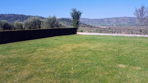 a large grassy yard with a fence in the background at La Torre Blanca in Cardona