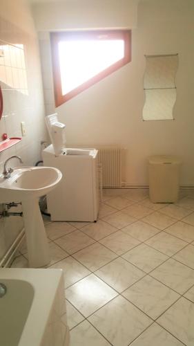 a bathroom with a sink and a toilet and a window at Vignobles Frey-Sohler in Scherwiller