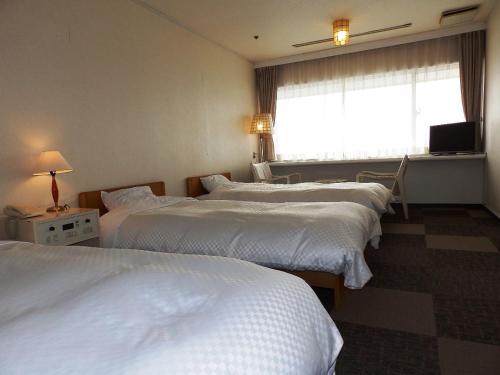 Postel nebo postele na pokoji v ubytování Itoen Hotel Toi