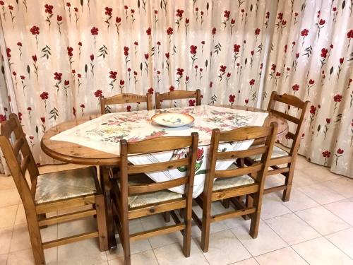 a dining room table and chairs with a curtain at TROUZINI VILLA 2 in Peyia