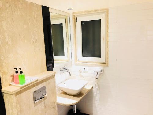 a bathroom with a sink and a toilet at City Empire New Delhi Train Station in New Delhi