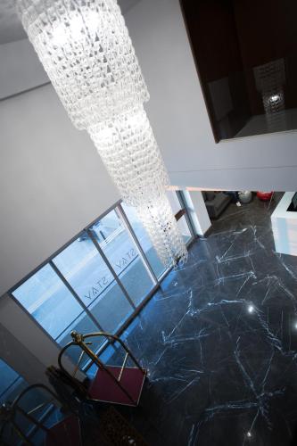 a chandelier hanging from a ceiling in a room at The Stay Furnished Apartments in Dbayeh