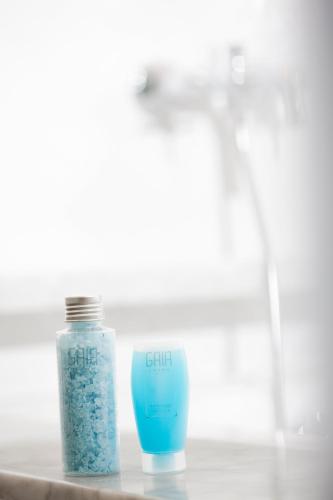 a bottle of blue liquid sitting on a counter at GAIA Cosmo Hotel in Yogyakarta