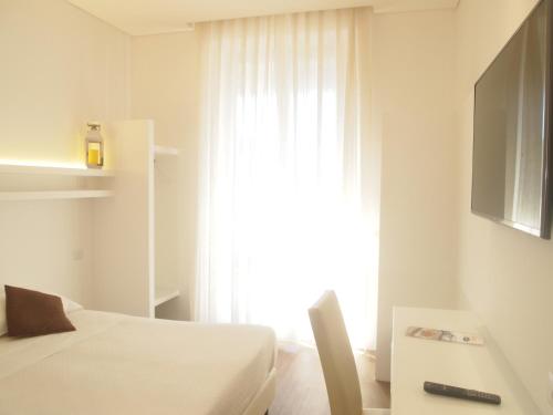 a hotel room with a bed and a window at Soggiorno Lo Stellino in Siena