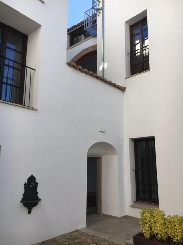 a white building with a staircase on the side of it at Casa Palacio Muñoz Chaves in Cáceres