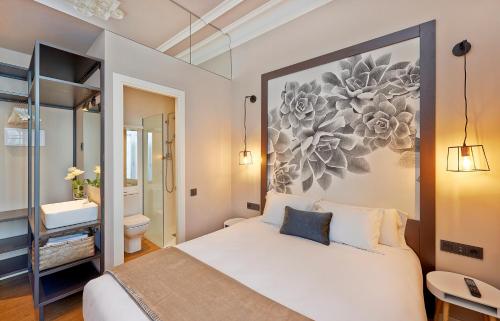 a bedroom with a large bed and a bathroom at Hostal Central Barcelona in Barcelona