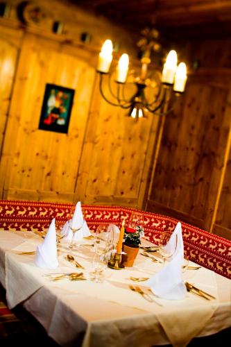a table with a white table cloth and glasses at Hotel Seefischer - Finest Hideaway in Döbriach