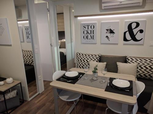 a dining table and chairs in a living room at Tingsryd Resort in Tingsryd