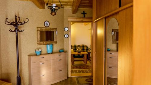 a room with a hallway with a dresser and a mirror at Chata Delta in Liptovský Mikuláš