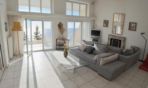 a living room with a couch and a fireplace at Villa Alibertini in Agios Gordios