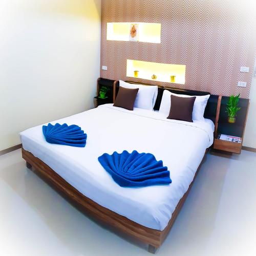 a bedroom with a large bed with blue towels on it at Walking Street Residence - Boutique Suites near the Beach & Walking Street in Pattaya South