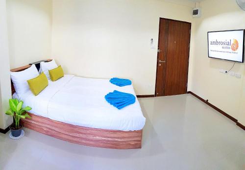 a bedroom with a bed with blue pillows on it at Walking Street Residence - Boutique Suites near the Beach & Walking Street in Pattaya South