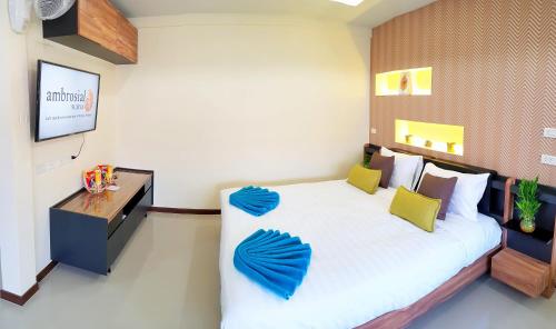a bedroom with a large bed and a television at Walking Street Residence - Boutique Suites near the Beach & Walking Street in Pattaya South