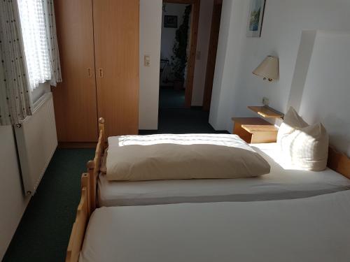 a bedroom with two beds and a hallway at Gasthof Schützenwirt in Steinach am Brenner