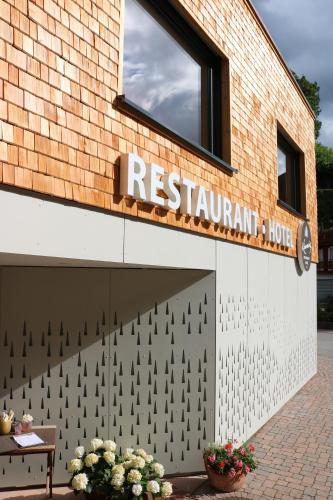 a restaurant sign on the side of a building at Hotel Kimmig in Bad Peterstal-Griesbach