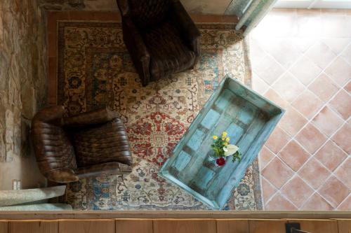a mirror sitting on a wall next to a chair at Casanova di Neri Relais in Montalcino