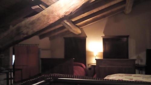 a bedroom with a bed and a lamp in a room at Valli Unite in Costa Vescovato