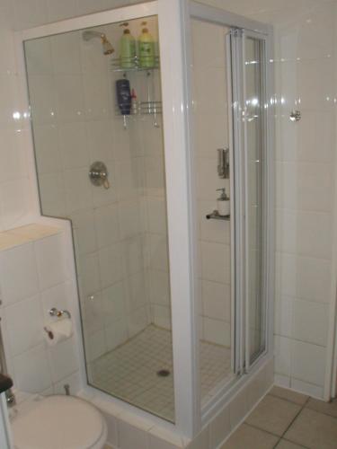 a shower with a glass door in a bathroom at WATERFRONT 15 QUAY WEST in Knysna