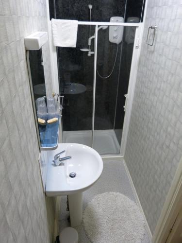 a bathroom with a sink and a shower at The Waverley Guest House in Whitby