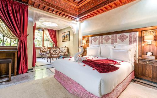 a bedroom with a large white bed in a room at Hivernage Secret Suites & Garden in Marrakech