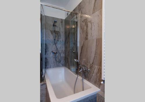 a bathroom with a shower and a bath tub at Appartamento vista Lago - Mary in Lezzeno