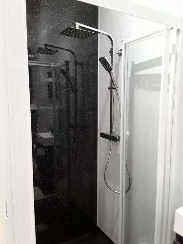 a shower with a glass door in a bathroom at Byers Guest house in Banavie