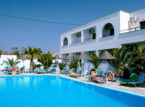 a large swimming pool in front of a hotel at Andreas Studio in Perissa