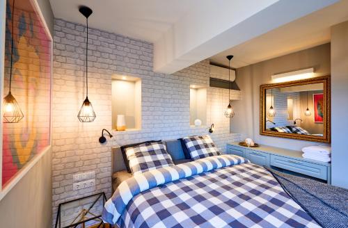 a bedroom with a bed and a mirror at Stylish and High-end Designer Apartments in City Center in Sofia