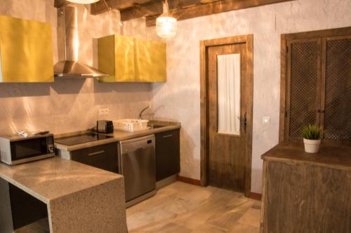 a kitchen with a sink and a counter top at Casa Mirador San Pedro in Arcos de la Frontera