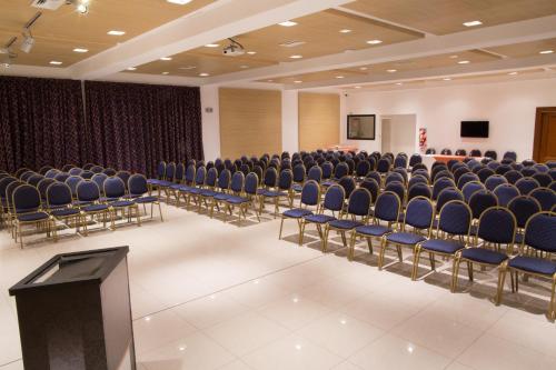 an empty room with chairs and a podium in it at Neper Hotel in Cordoba