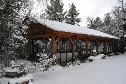 a gazebo with snow on top of it at Hotel Rural Convento Santa Maria de la Sierra in Arroyo Frio