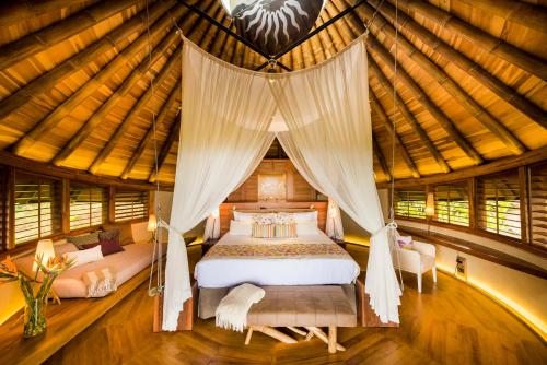 a bedroom with a bed in a yurt at Origins Lodge in Bijagua