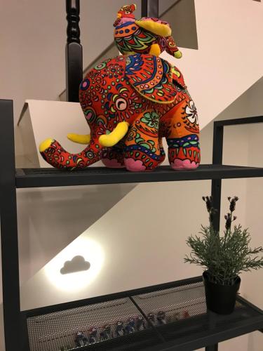 a colorful elephant statue sitting on a shelf at Season Inn in Wujie