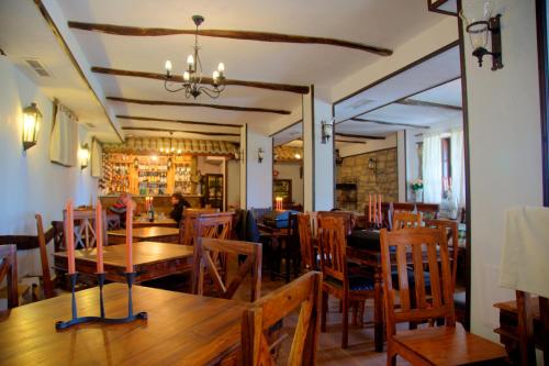 a dining room with wooden tables and chairs at Villa Bulgara Eco in Madara