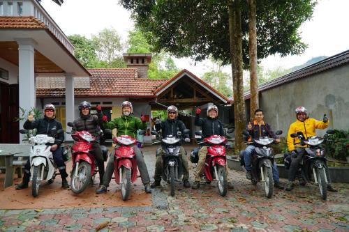a group of people on motorcycles posing for a picture at Huy Trung Homestay in Bắc Hà