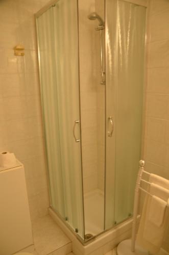 a glass shower in a bathroom with a toilet at Villa Flamingo in Villasimius