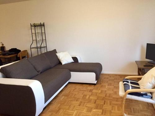 a living room with a couch and a table at Münster City Apartment in Münster